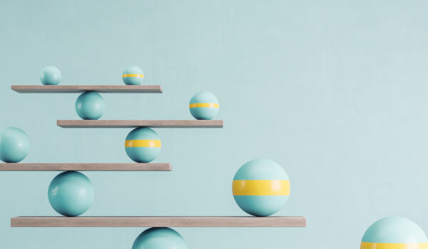 Blue and yellow balls balanced on wooden platforms