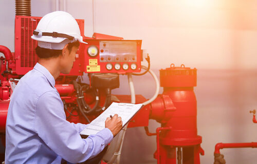 Engineer inspecting fire safety equipment