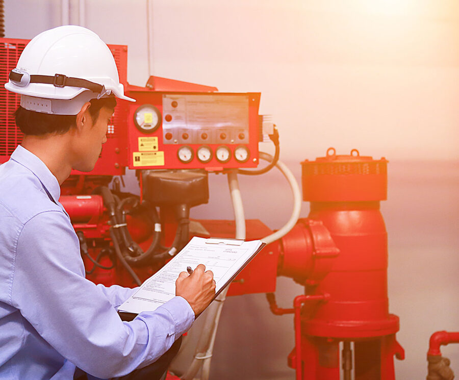 Engineer inspecting fire safety equipment